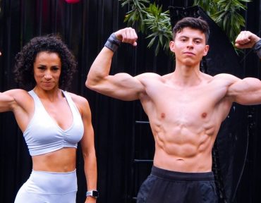 A fit man and woman flex muscles in activewear outdoors in Mexico City.